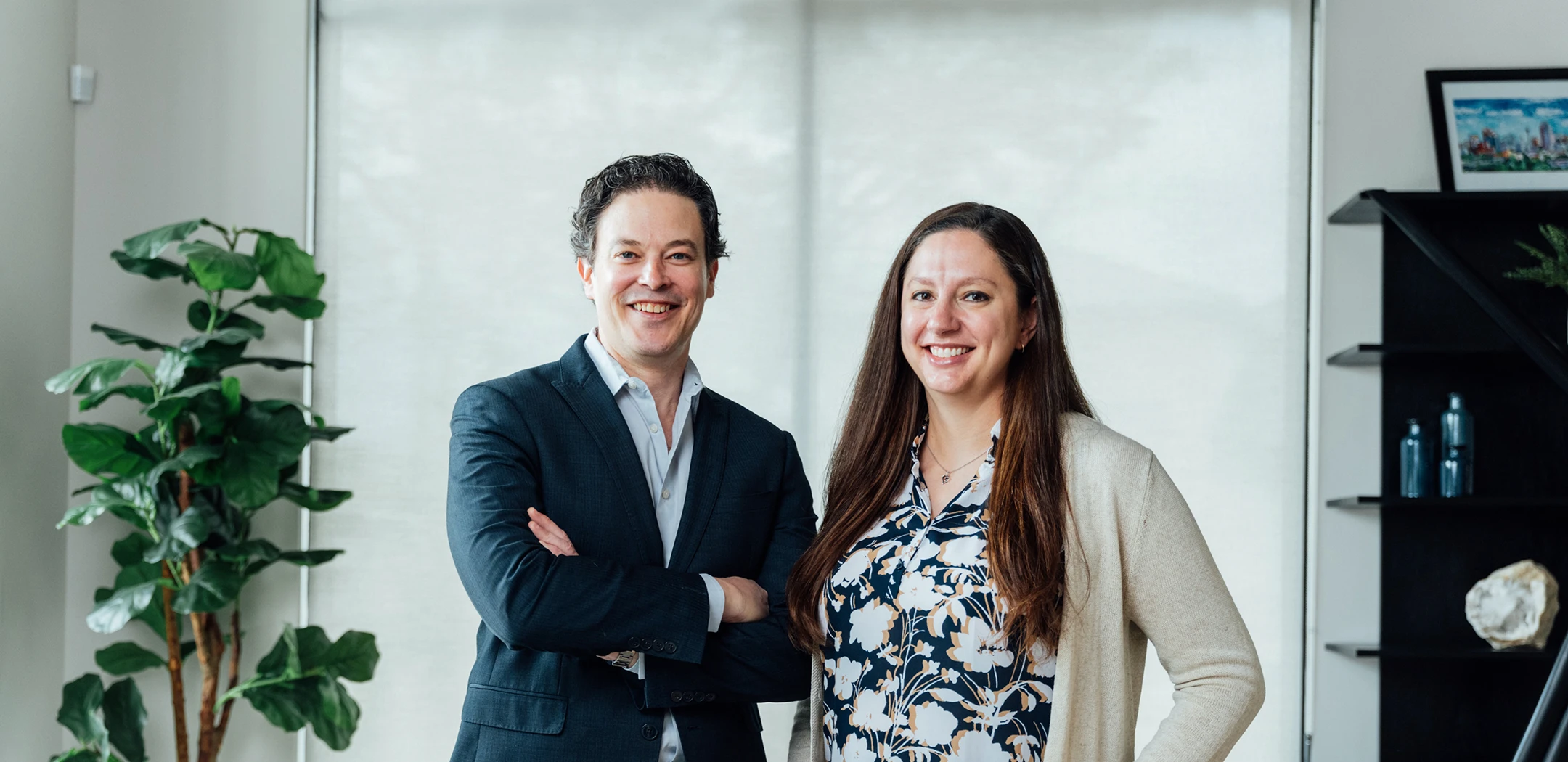Dr Stallworth and Dr rokosz people standing together in modern office with plant and glass walls - Doctors in San Antonio, TX
