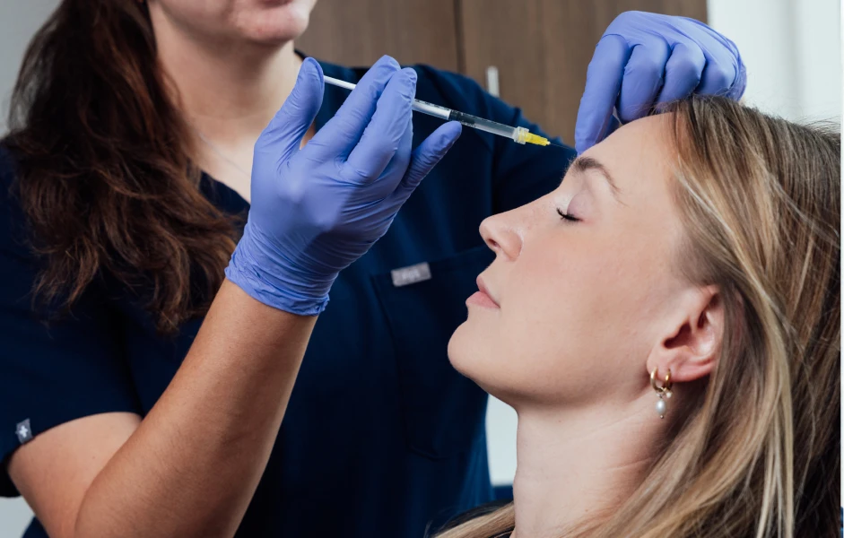 Medical professional administering injectable treatment to female patient in clinical setting - Non surgical in San Antonio, TX
