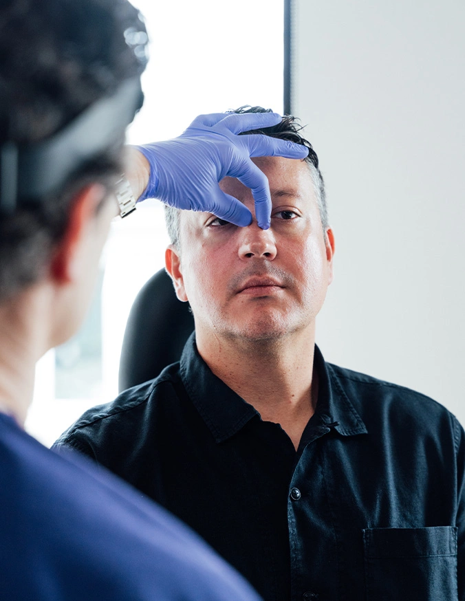 doctor Stallworth MD examining patient's nose during comprehensive medical exam - Septoplasty in San Antonio, TX
